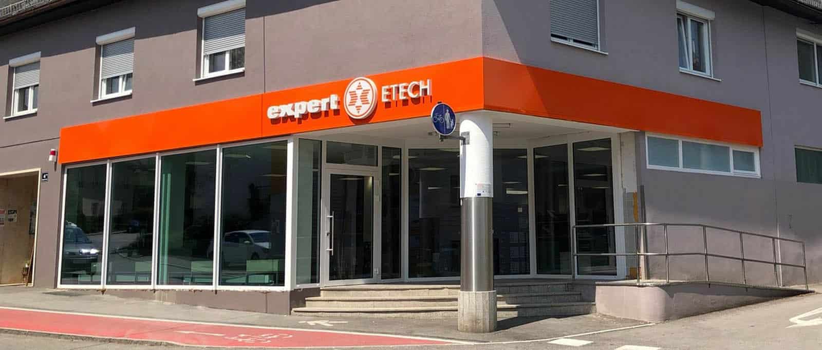 ETECH-Filiale Neuhofen: Außenansicht des Elektrofachhandels mit orangefarbener Fassade und großen Schaufensterfronten